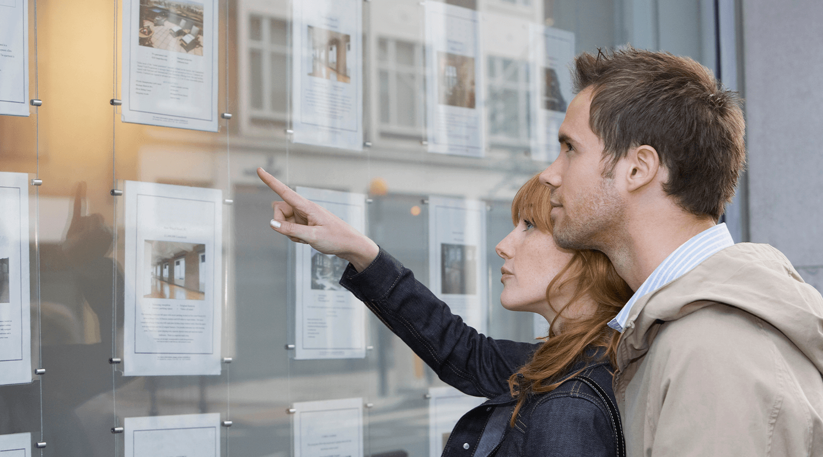 Couple looking at future homes at estate agents